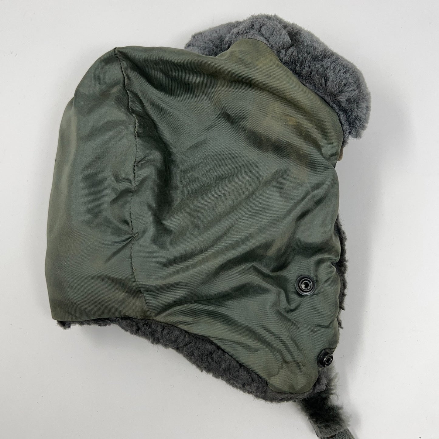 Vintage military helmet in green with faux fur lining, side view