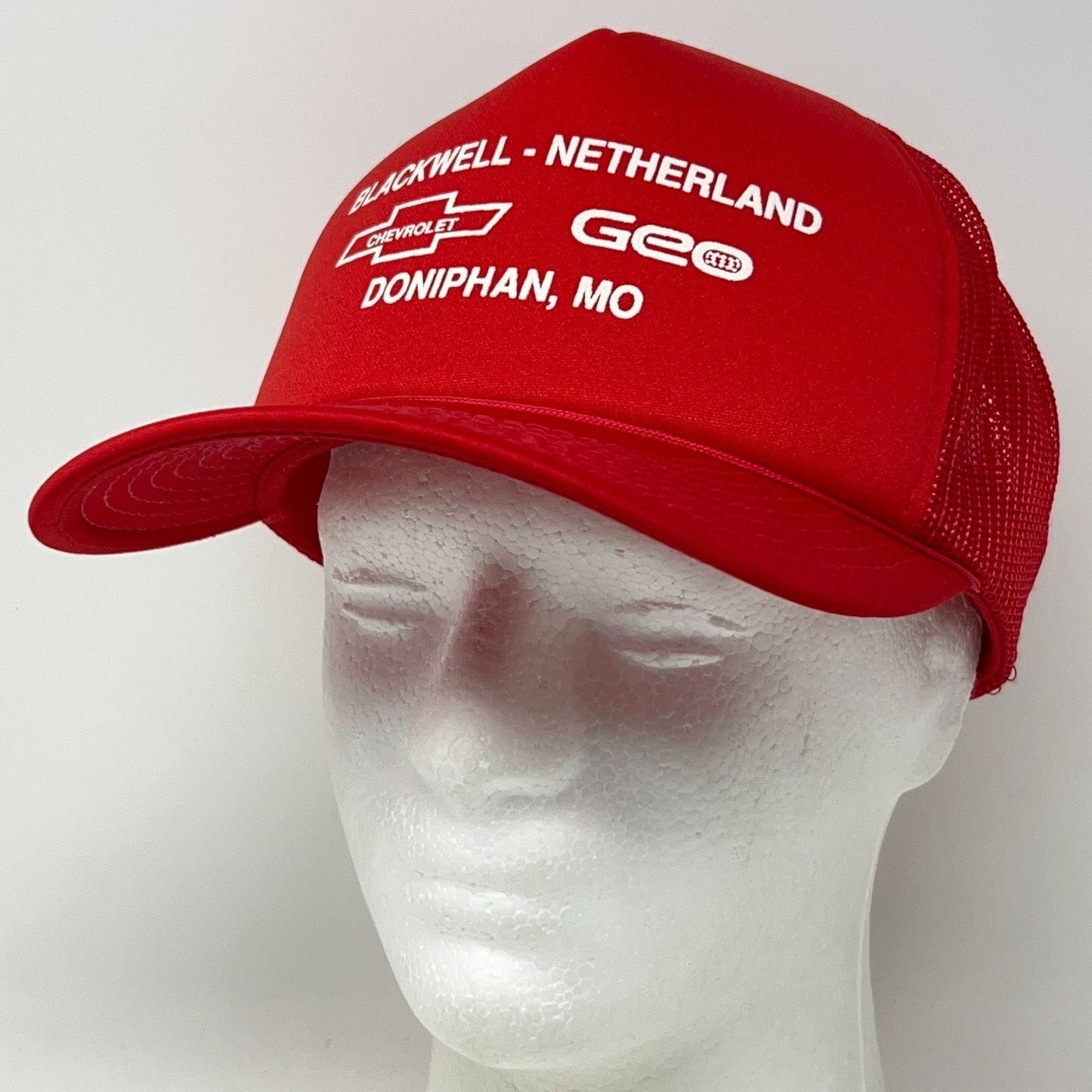 Vintage 1990s red Chevrolet trucker hat with mesh back and embroidered logo