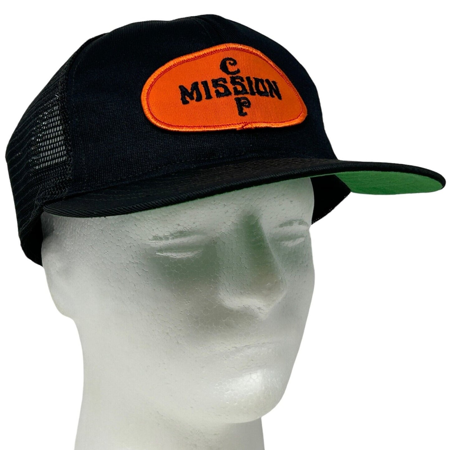 Vintage black trucker hat with orange Mission CP logo on front and green brim