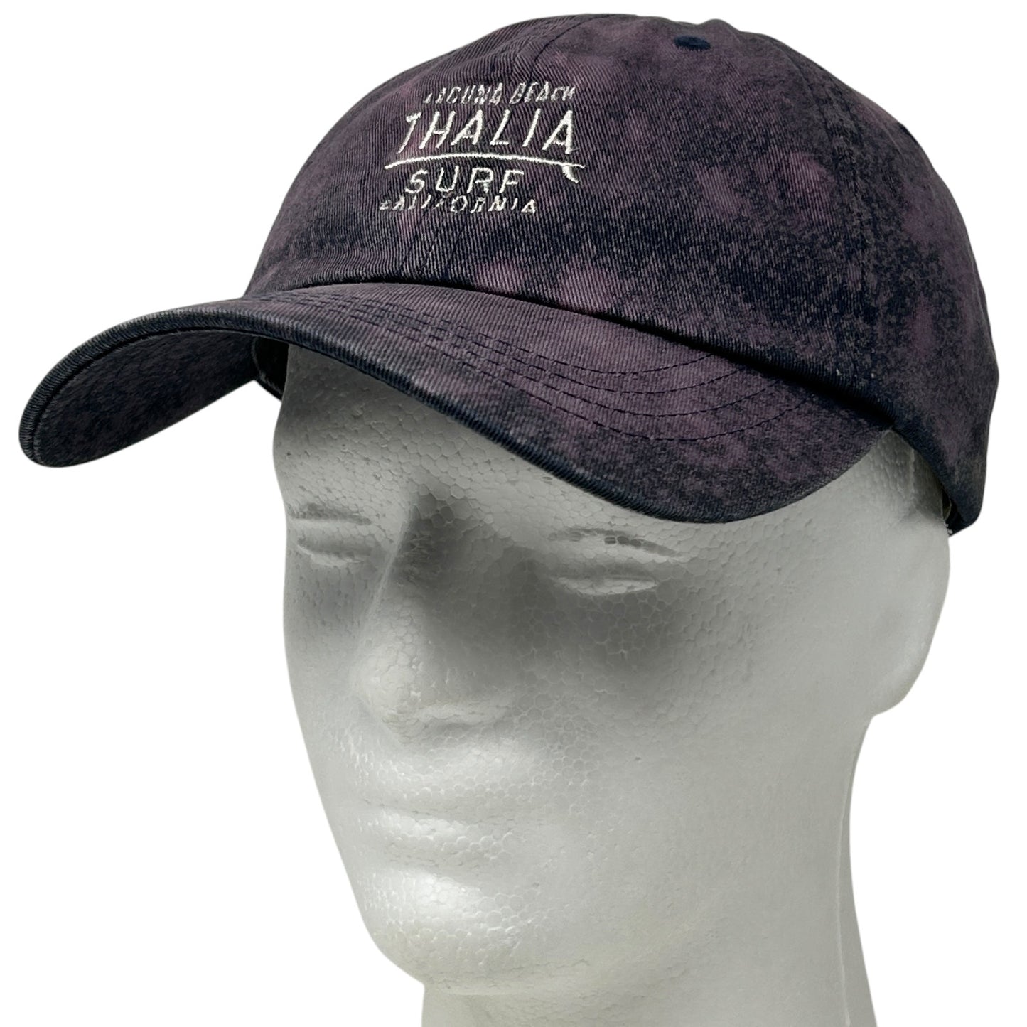 Front view of a dark navy Thalia Surf Shop baseball cap with white logo and adjustable strap