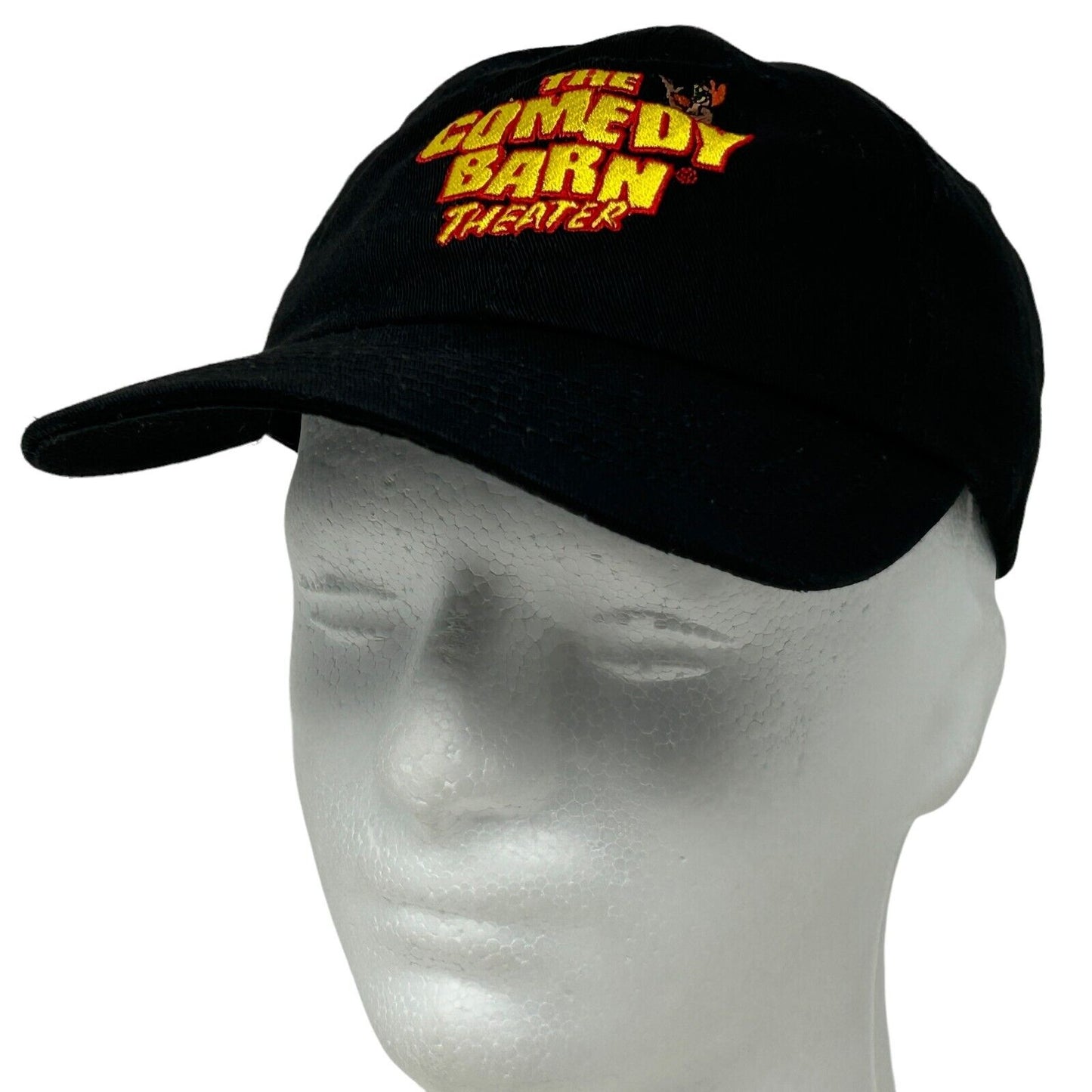 Black baseball cap with front logo featuring The Comedy Barn Theater in bold colors