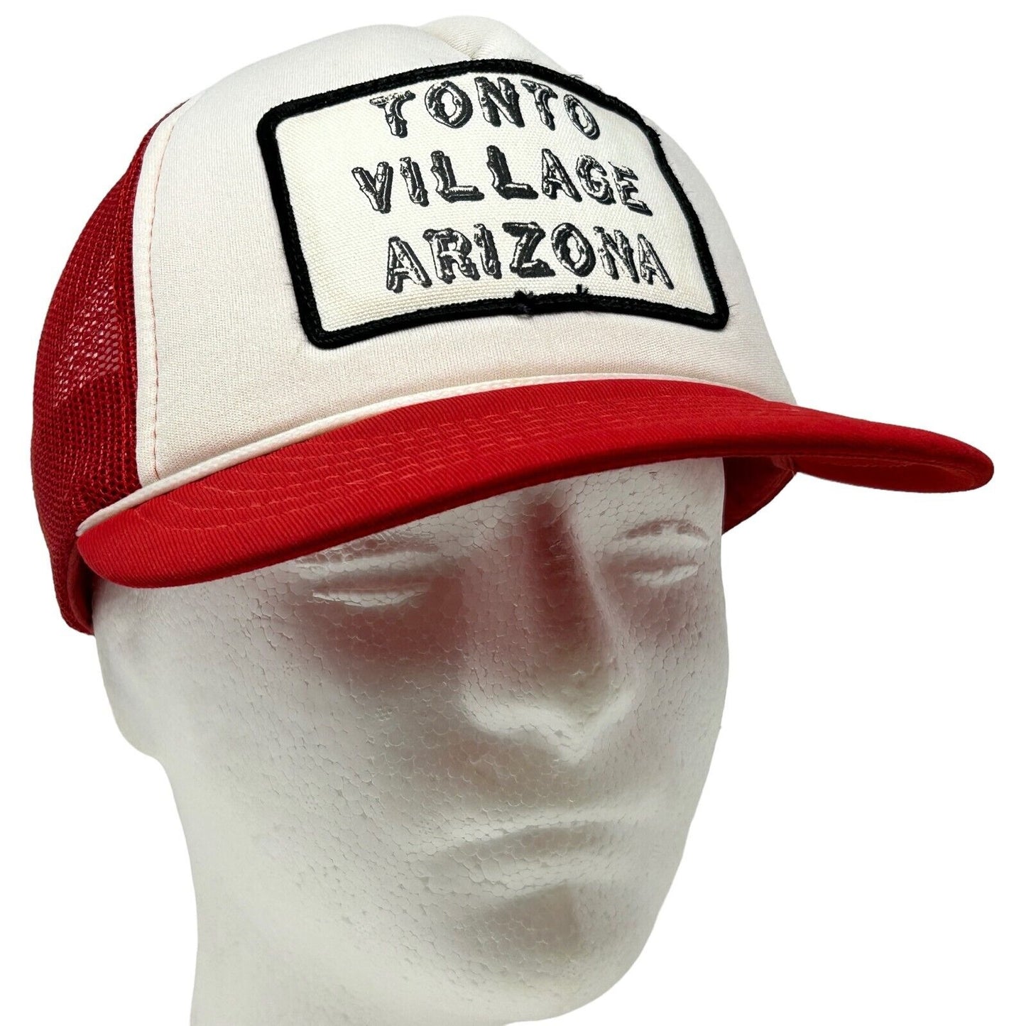 Vintage red and white trucker hat with Tonto Village Arizona logo on front, featuring a mesh back