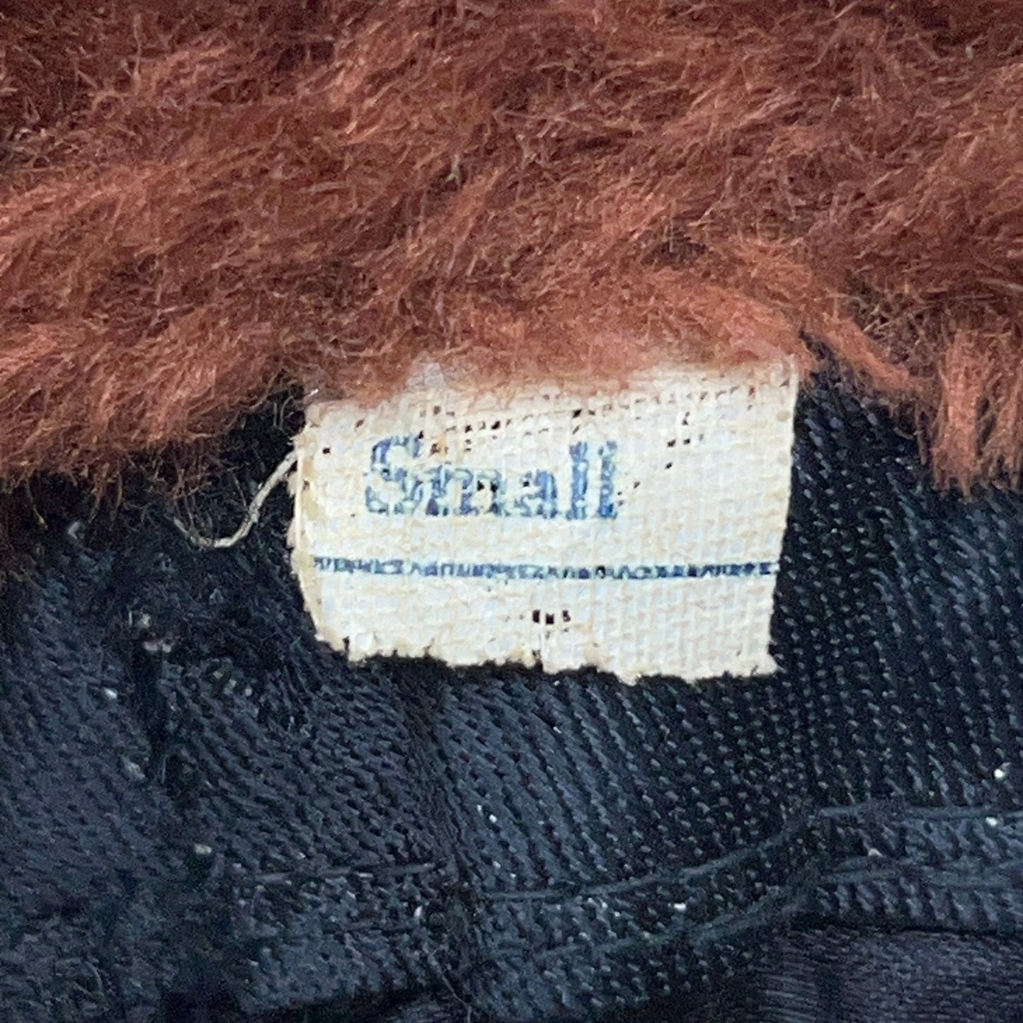 Vintage trapper hat in brown, small size, featuring a soft fur exterior and classic design