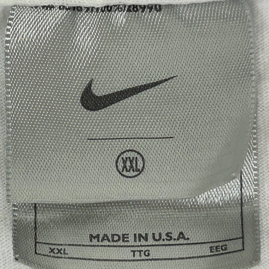 Detailed close-up of a vintage Nike T-shirt tag showcasing Nike T-Shirt Tag History from the 2000s