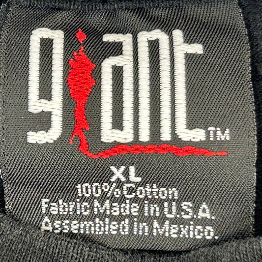 Close-up of a vintage Giant t-shirt tag showcasing its logo and fabric details for Giant T-Shirt Tag History