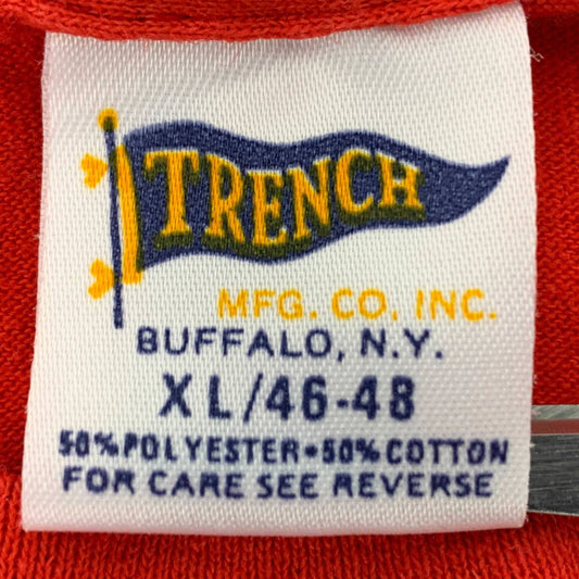 Trench T-Shirt Tag History featuring an authentic vintage tag from the 1980s with brand details