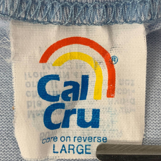 Close-up of a Cal Cru T-Shirt Tag showcasing its vintage design and care instructions for tag history
