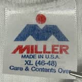 Close-up of a vintage Miller t-shirt tag showcasing the Miller T-Shirt Tag History from the 1980s