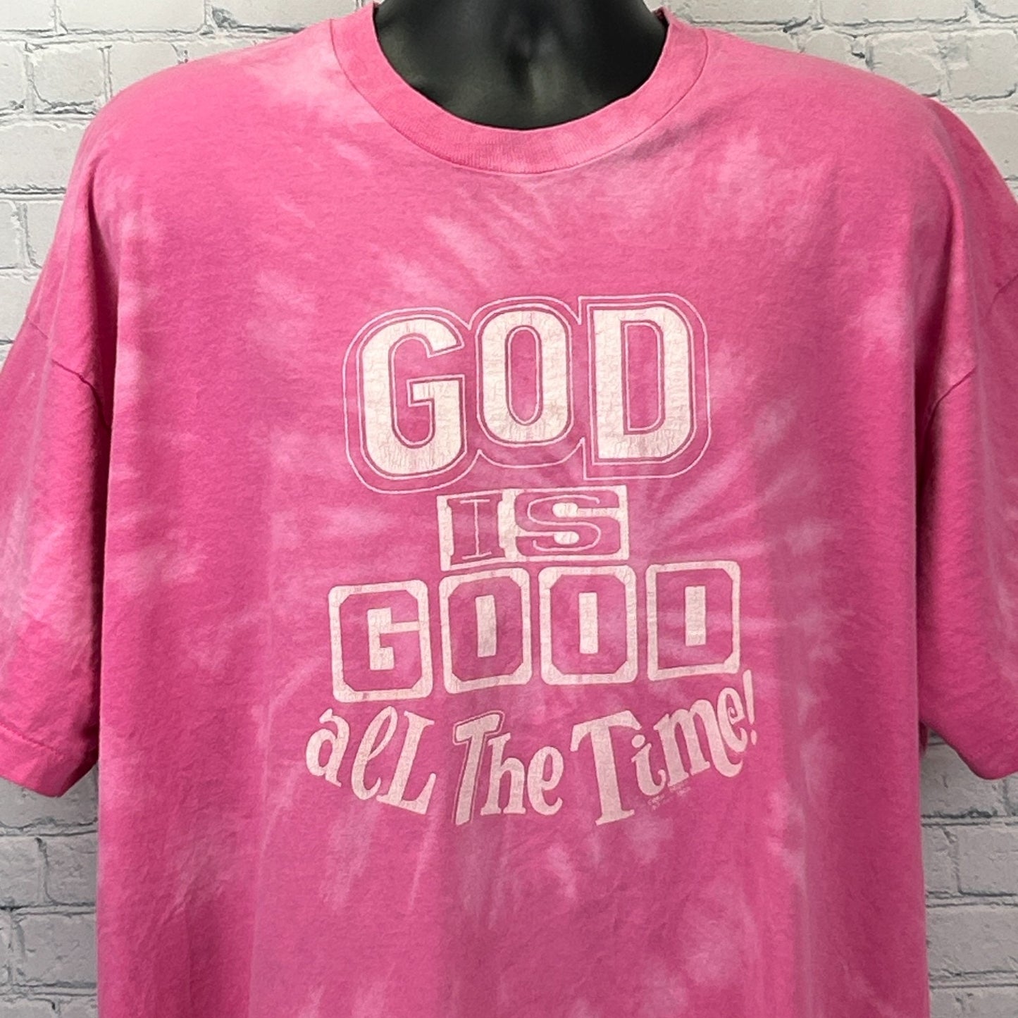 Front view of a pink Vintage T Shirt with the text 'God is Good All The Time!' in bold lettering