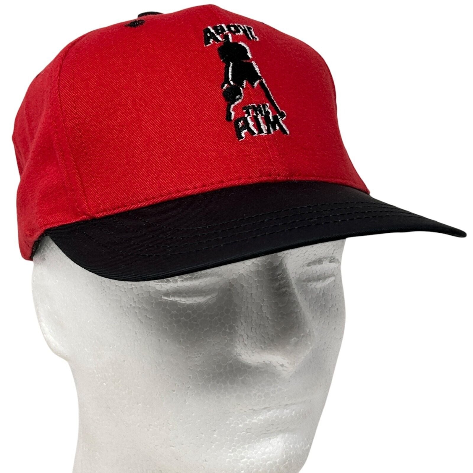 Red Above The Rim hat with black brim and embroidered logo on the front, adjustable size for all