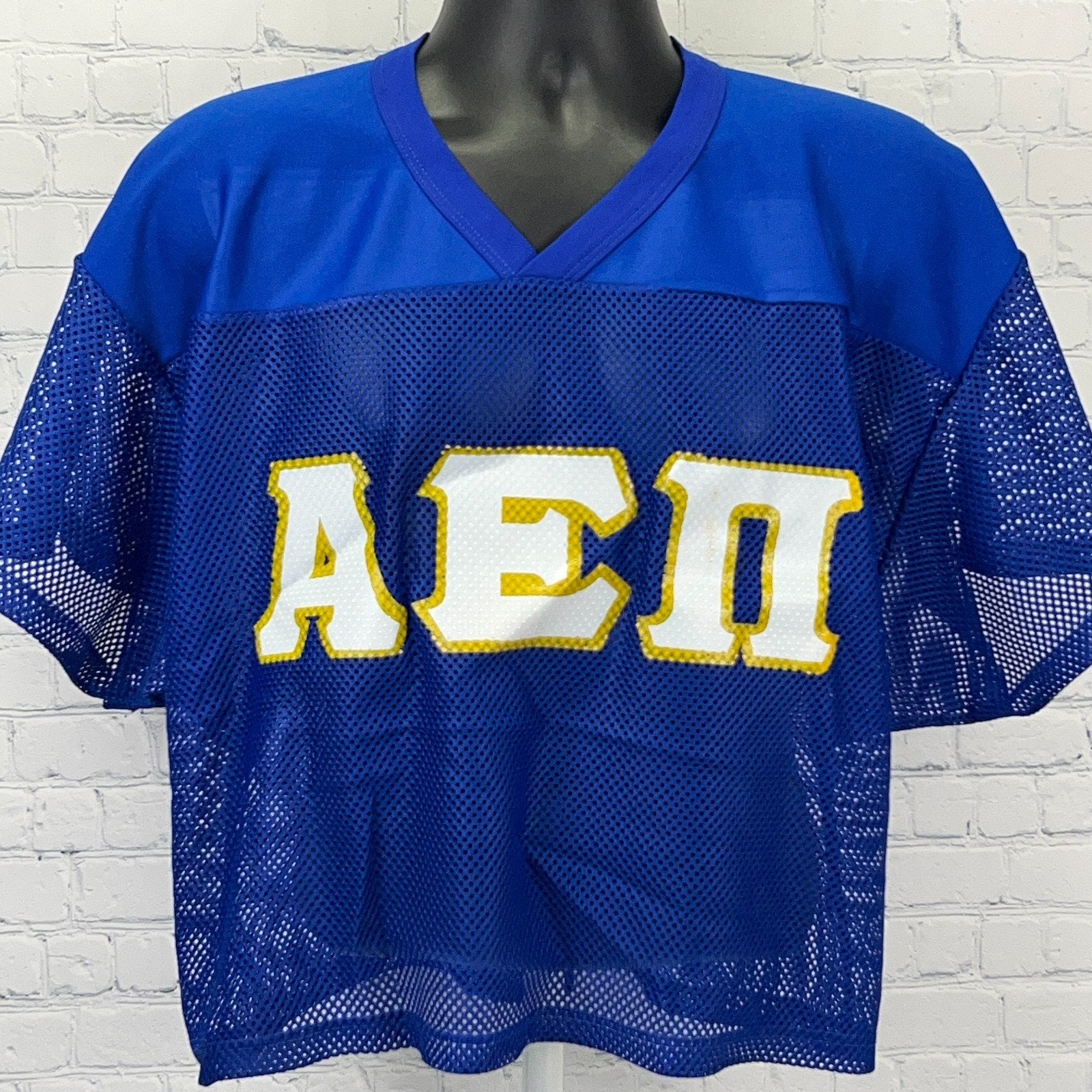 Russell Athletic blue AEPi mesh jersey featuring large yellow logo on front, short sleeves and loose fit