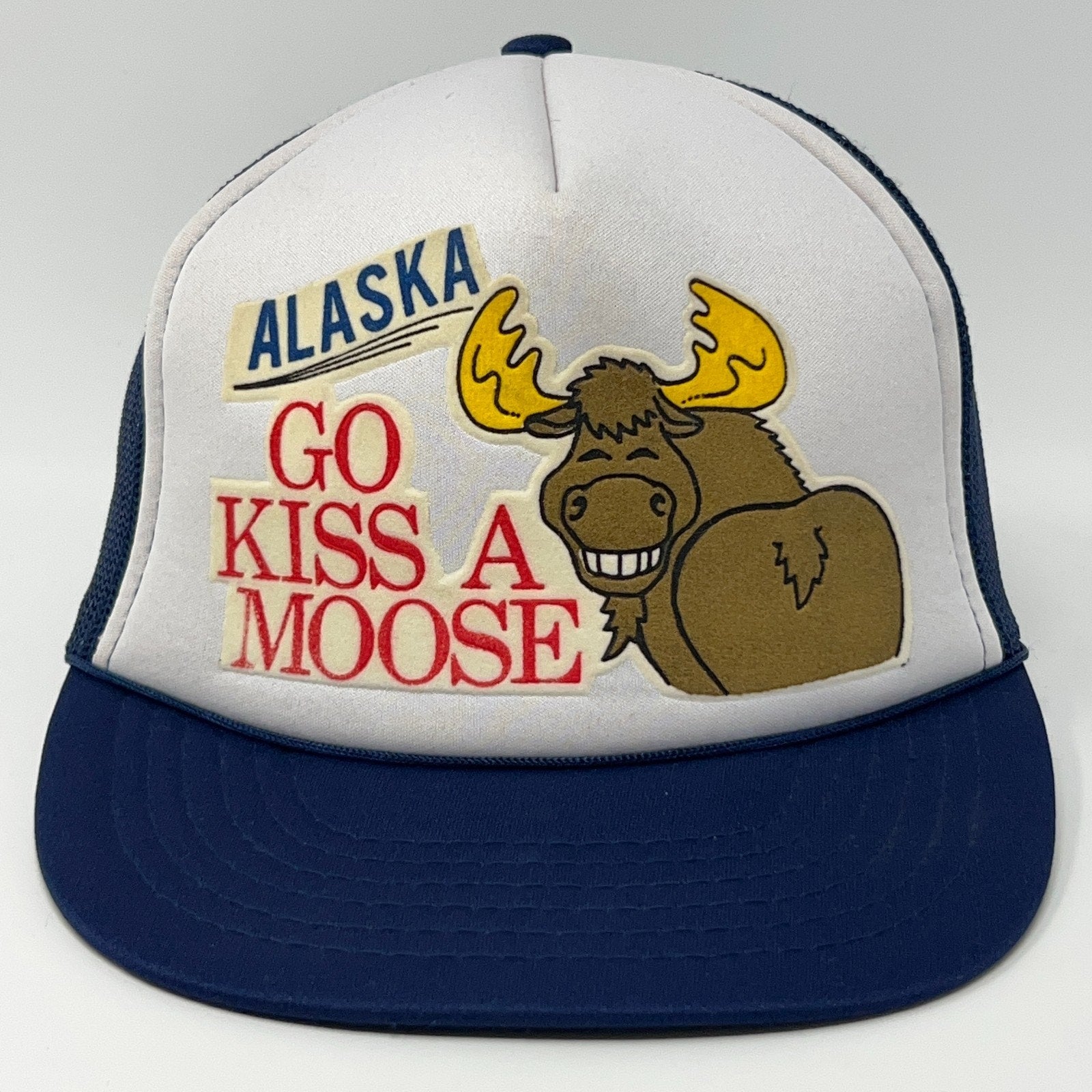 Front view of a Vintage Alaska cap featuring a moose graphic and the phrase Go Kiss A Moose