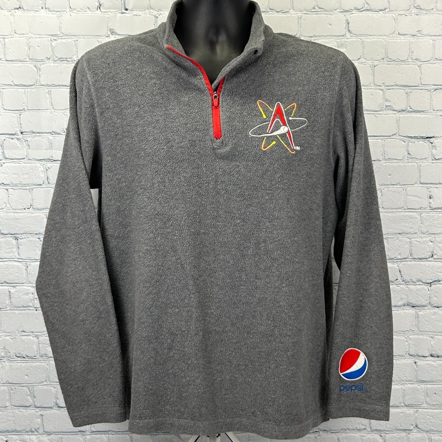 Gray Pepsi jacket featuring Albuquerque Isotopes logo on front and Pepsi logo on sleeve with red zipper detail