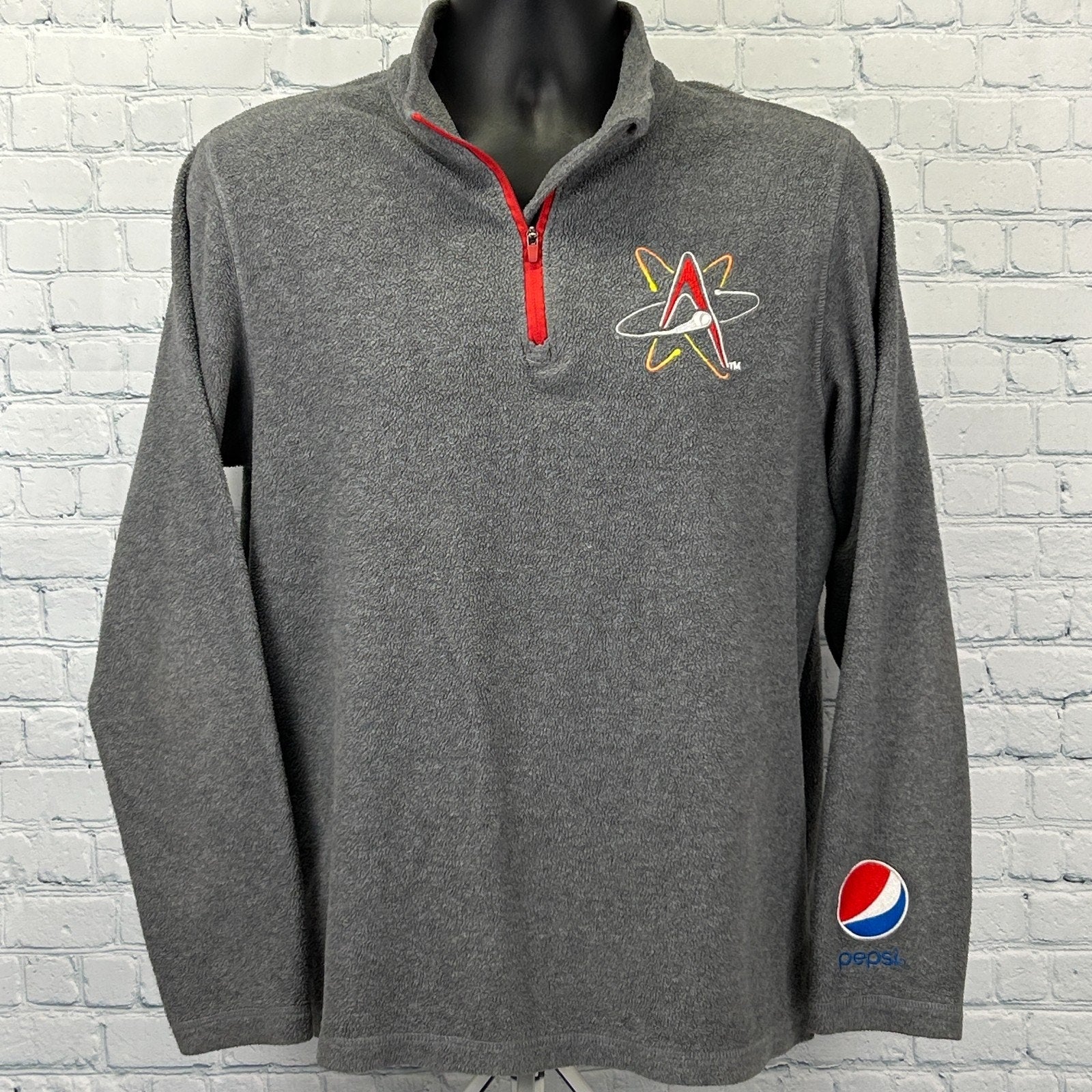 Gray Pepsi jacket featuring Albuquerque Isotopes logo on front and Pepsi logo on sleeve with red zipper detail