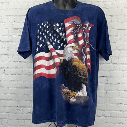 The Mountain American Flag T-Shirt featuring an eagle and stormy background in blue color