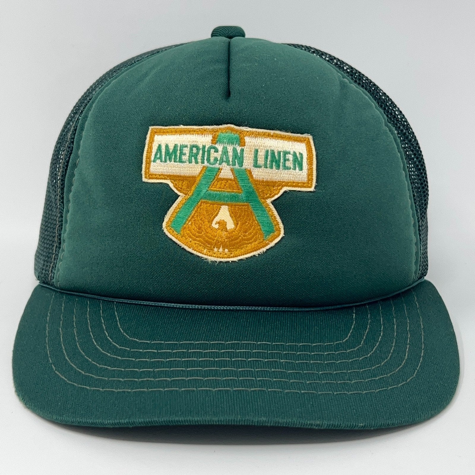 Front view of Vintage Green Trucker Hat featuring American Linen logo, adjustable size for comfort