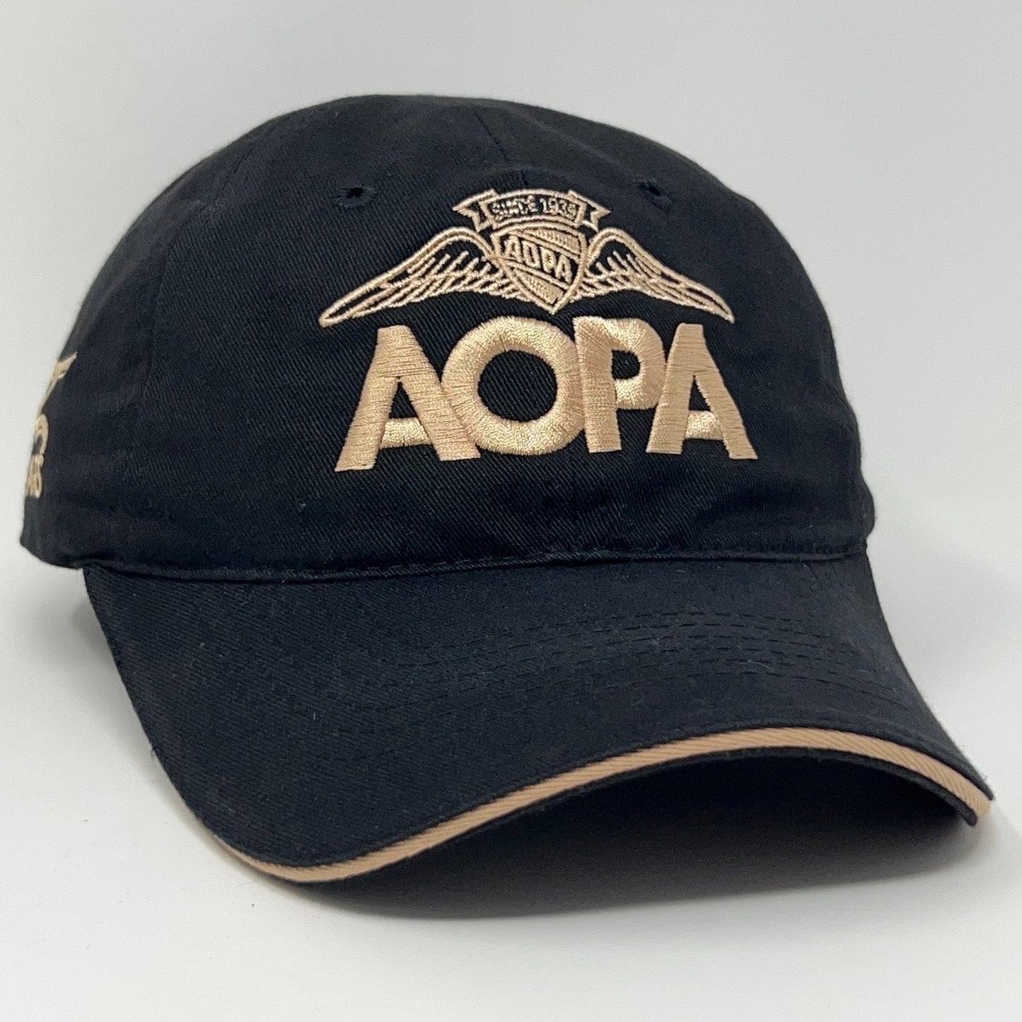 Black AOPA cap with embroidered logo and wings, front view showcasing size and detail