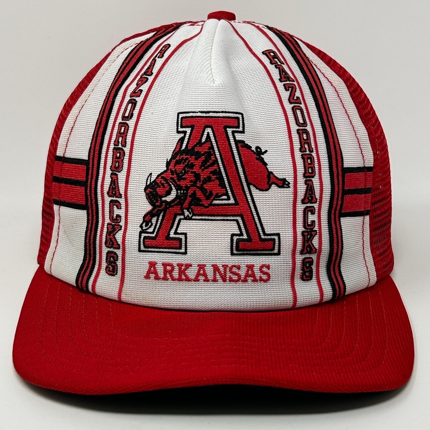 Front view of a red and white Arkansas Razorbacks Hat with logo and bold stripe design