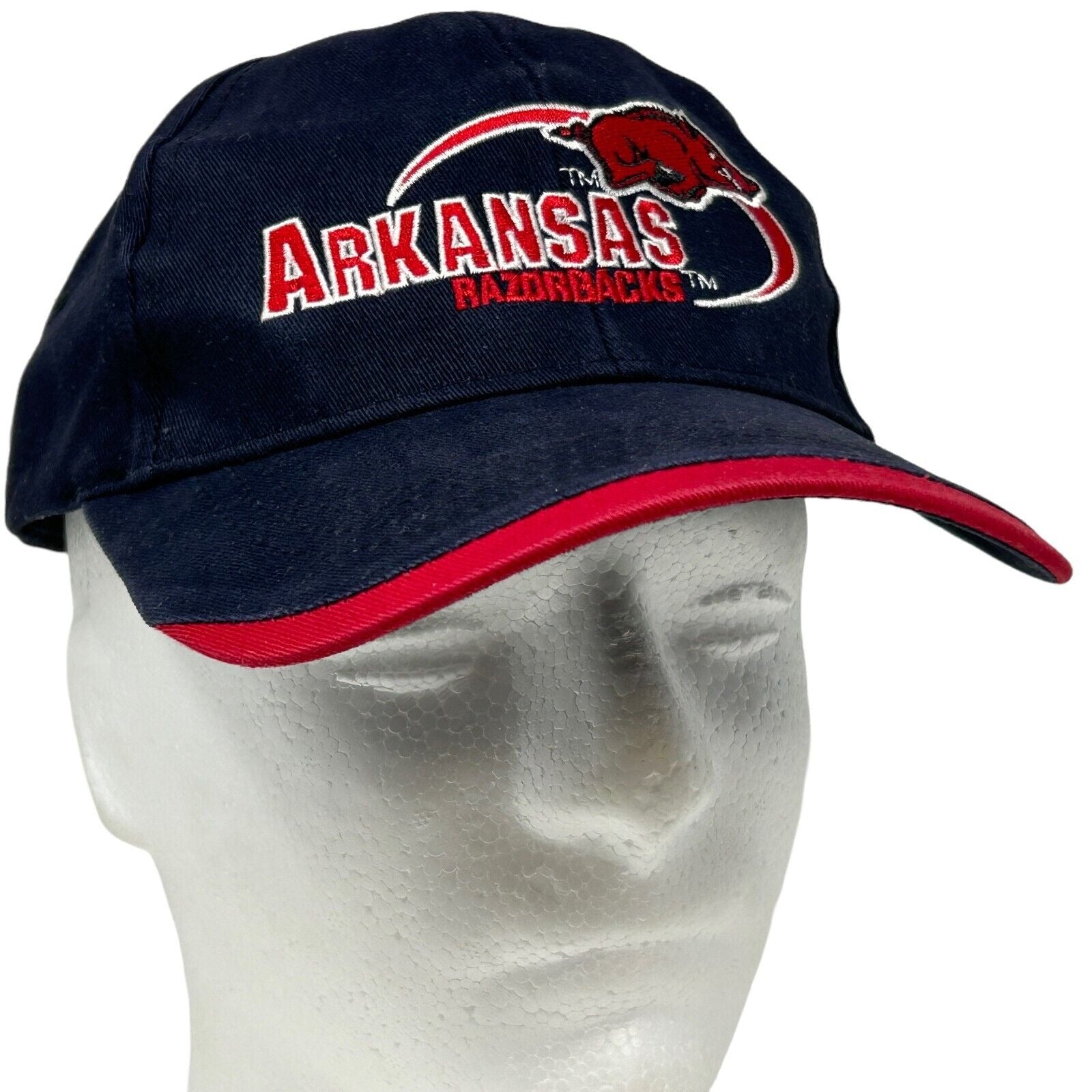 Navy blue Arkansas Razorbacks baseball cap with red brim and embroidered logo on the front