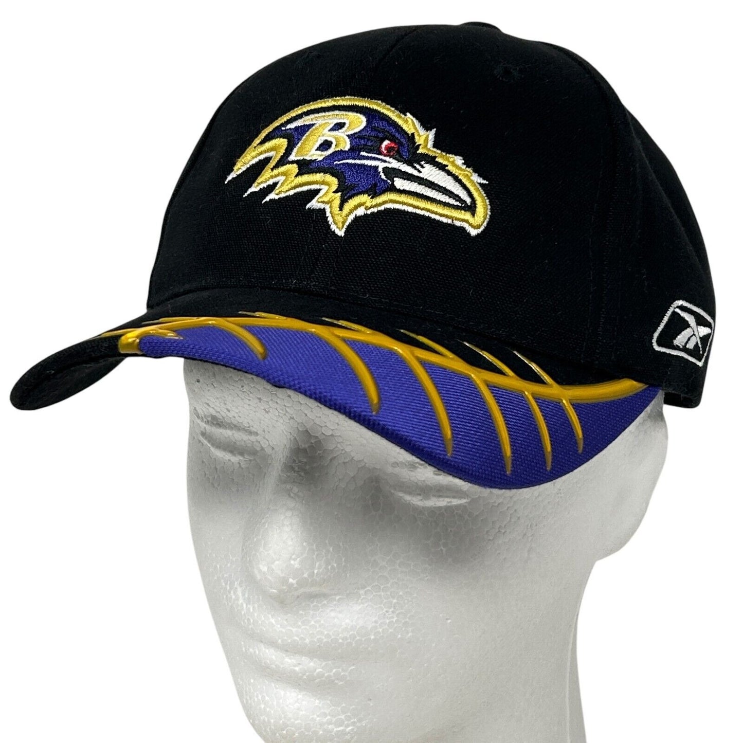 Black Reebok Baltimore Ravens hat with yellow and purple logo embroidered on the front and bill detail