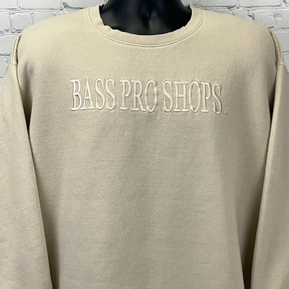 Front view of a cream-colored Bass Pro Shops sweatshirt with embroidered logo
