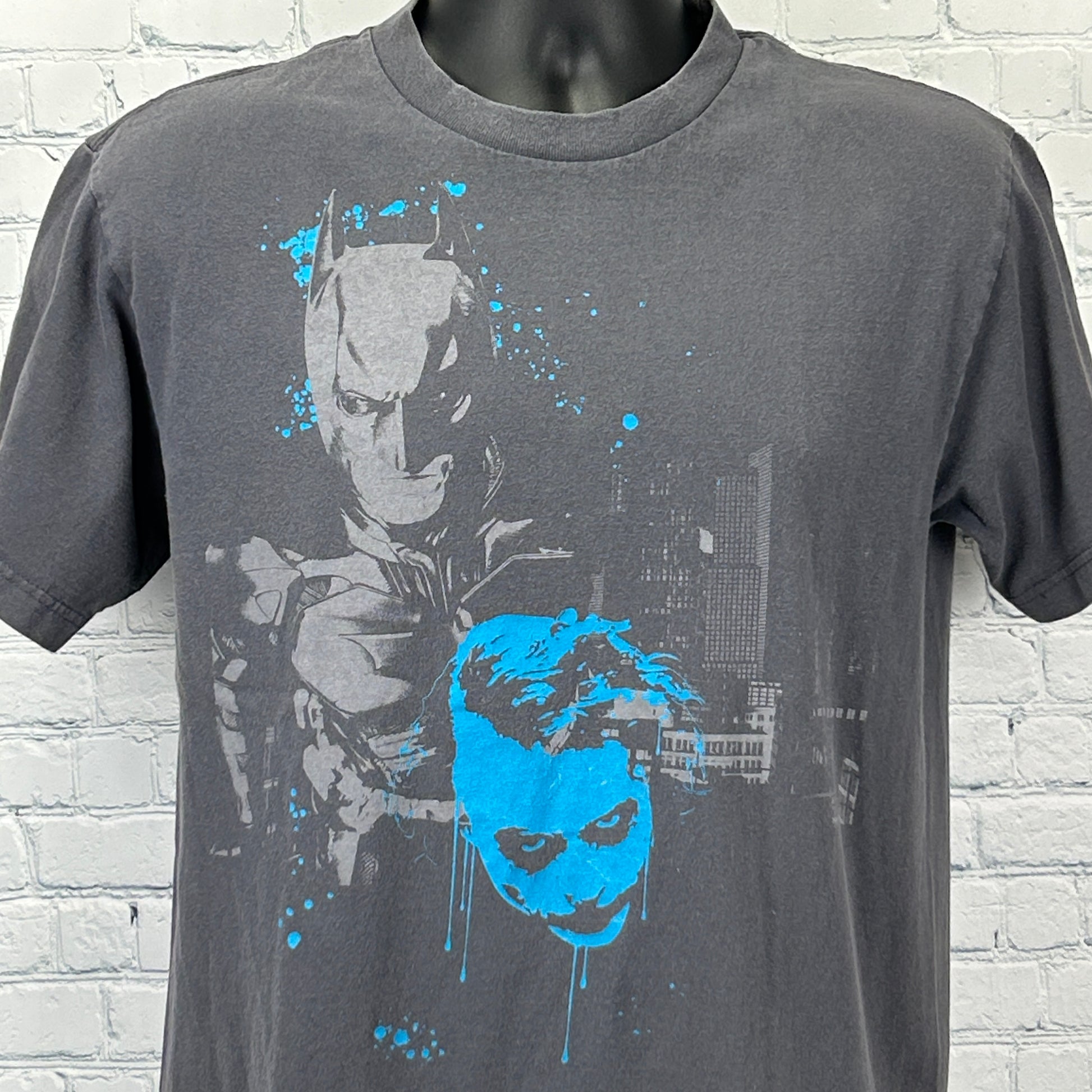 Gray DC Comics T-Shirt featuring Batman and Joker The Dark Knight graphic on the front