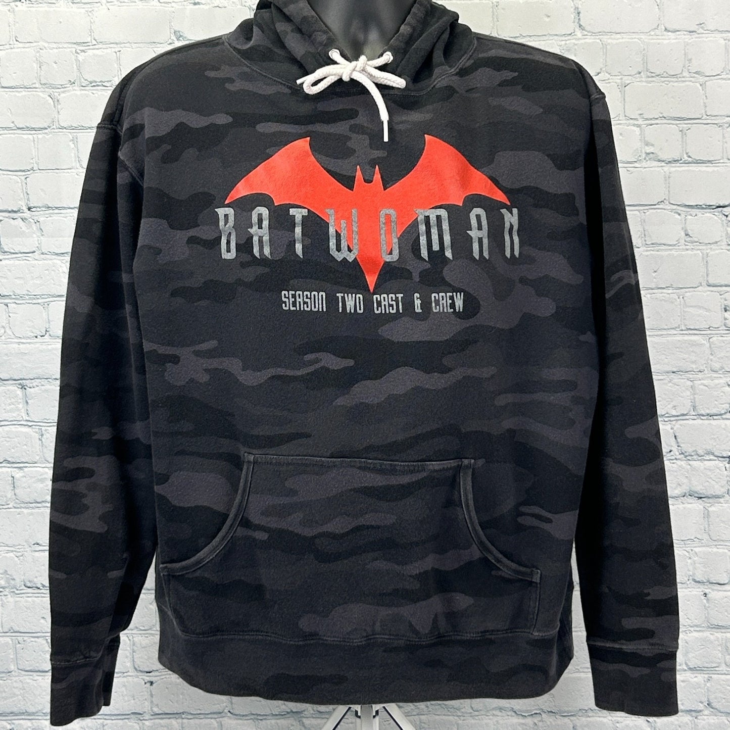 Front view of black camouflage Batwoman Hoodie featuring red logo and 'Season Two Cast & Crew' text