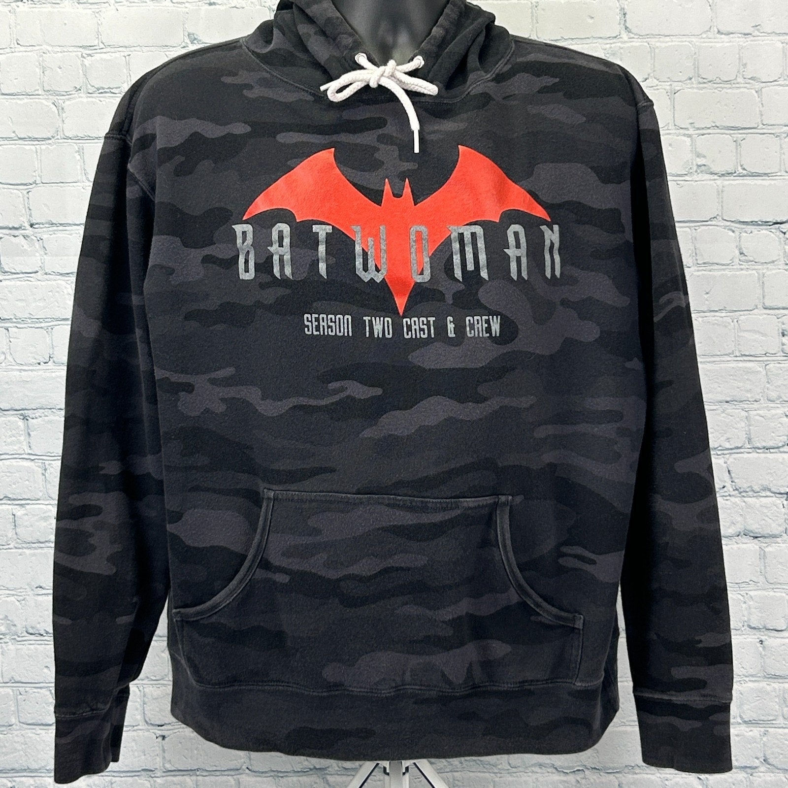 Front view of black camouflage Batwoman Hoodie featuring red logo and 'Season Two Cast & Crew' text