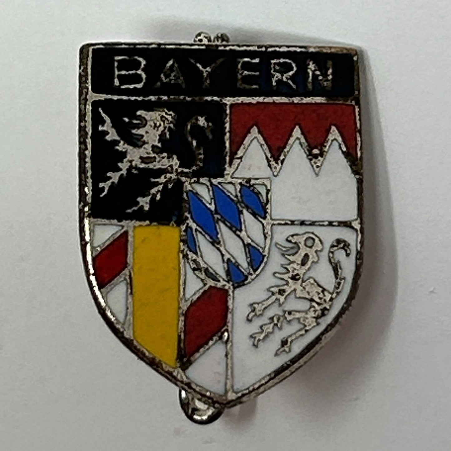 Vintage Bavaria enamel pin featuring a shield design with colors red, black, white, and yellow