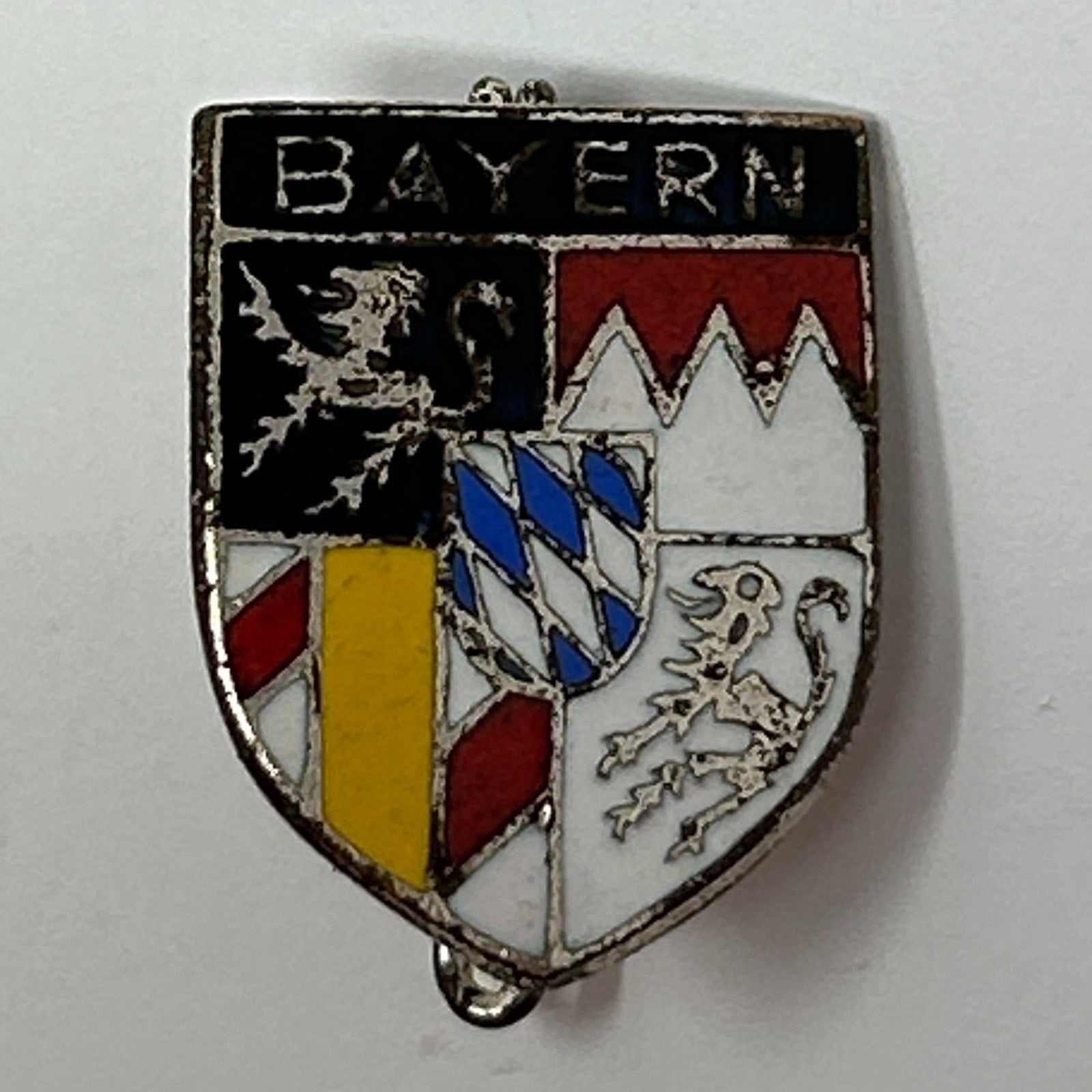 Vintage Bavaria enamel pin featuring a shield design with colors red, black, white, and yellow