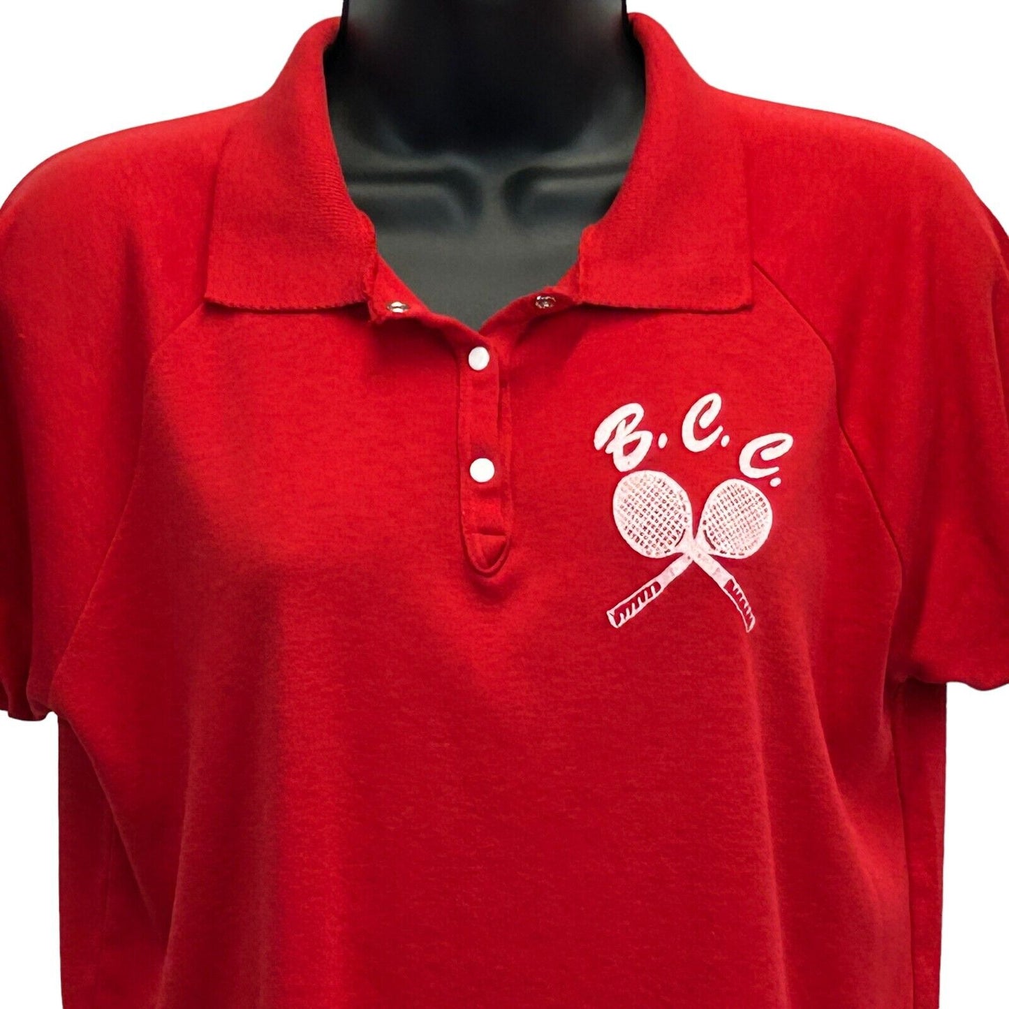Red TK2 Polo Shirt featuring BCC Tennis logo with two crossed racquets, front view, size details available