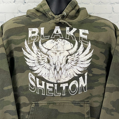 Olive camo hooded sweatshirt featuring Blake Shelton graphic with wings and skull design