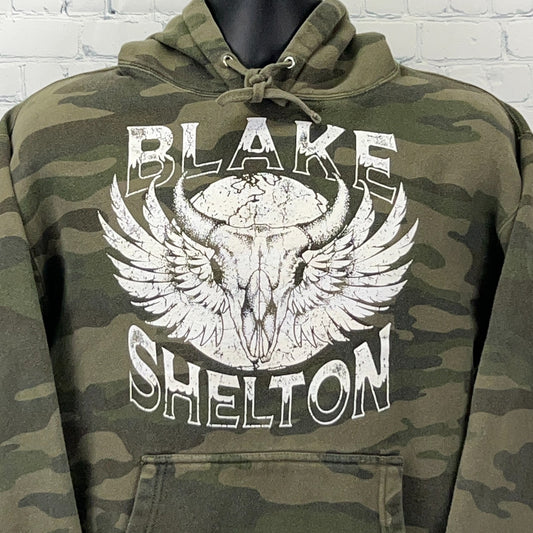 Olive camo hooded sweatshirt featuring Blake Shelton graphic with wings and skull design