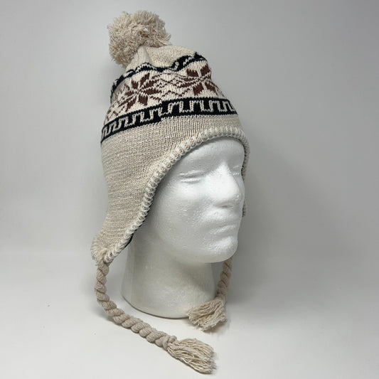 Unbranded beige beanie with pom-pom, ear flaps, and tribal pattern, shown on a mannequin head