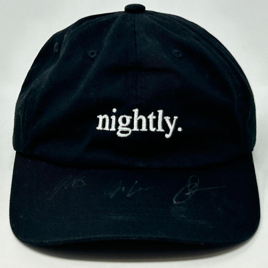 Black Yupoong cap with white nightly. embroidery, featuring a classic curved brim design