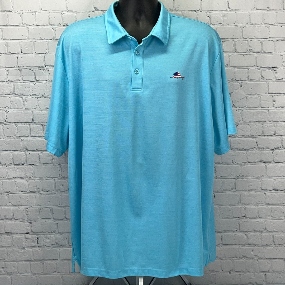 Light blue Ocean & Coast polo shirt with logo, featuring a relaxed fit for casual fishing outings