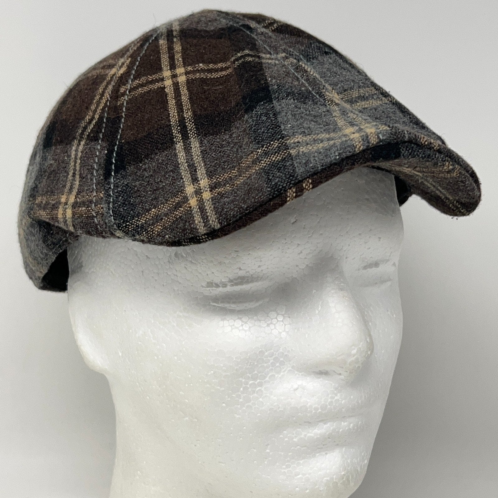 Brown and grey plaid flat cap in front view, featuring a classic design and soft fabric