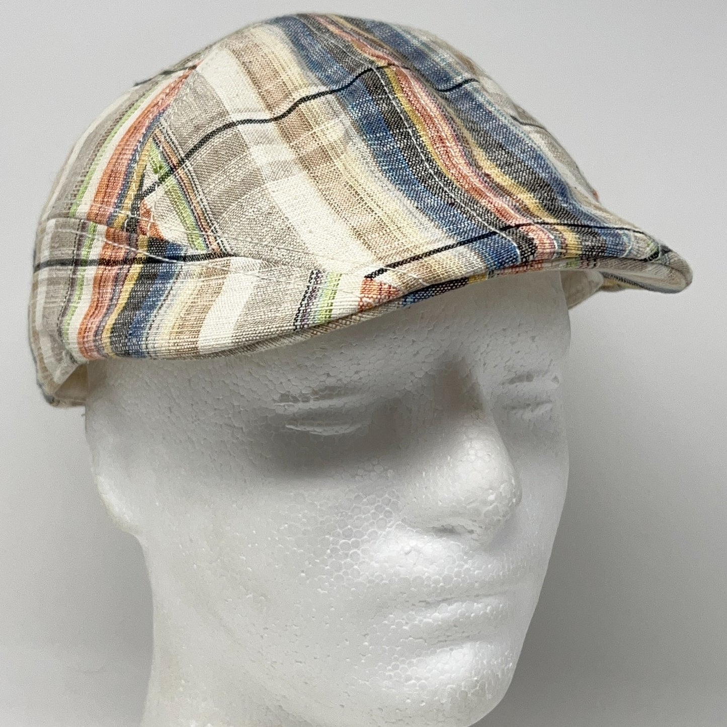Multicolored Scala Flat Cap with plaid pattern view from front on mannequin head