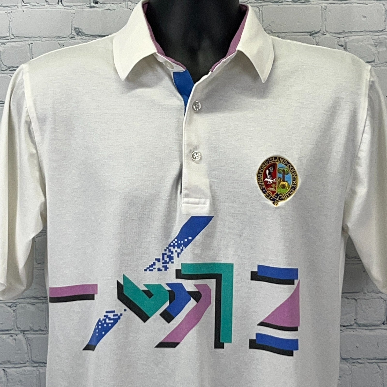 Vintage Golf Polo in white with colorful geometric design and logo on the chest