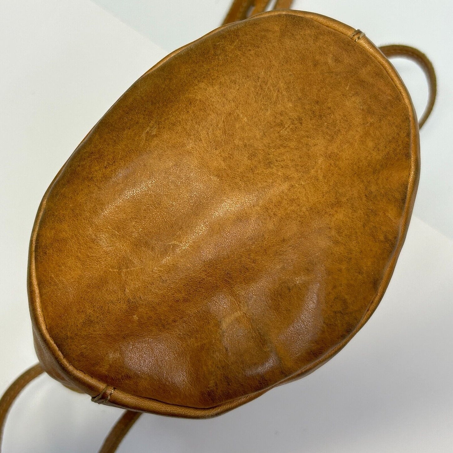 Madewell leather crossbody bag in tan, round shape, front view