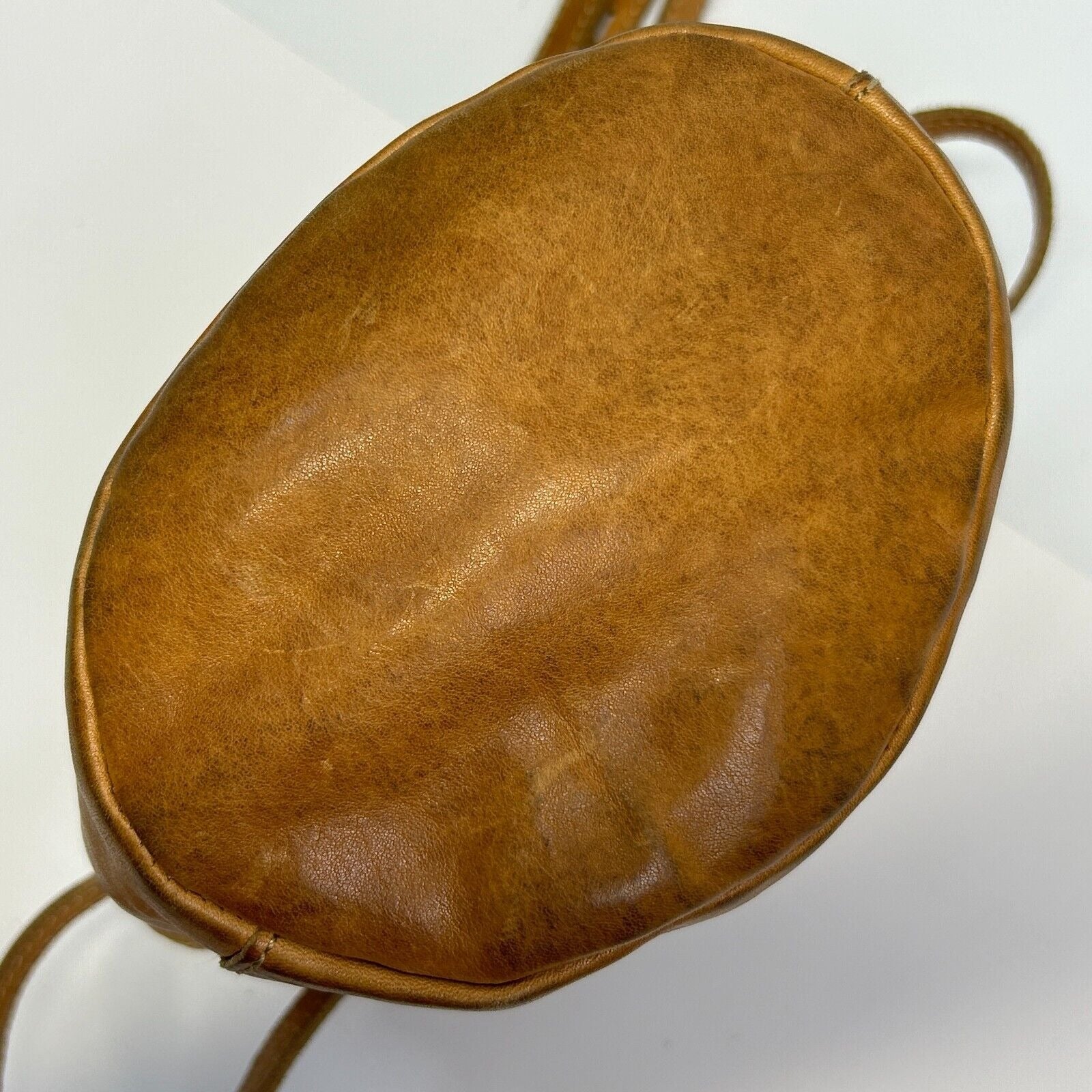 Madewell leather crossbody bag in tan, round shape, front view