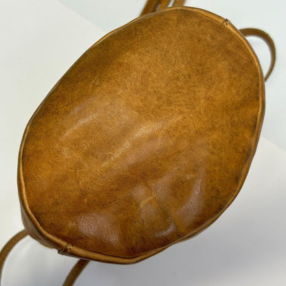 Madewell leather crossbody bag in tan, round shape, front view
