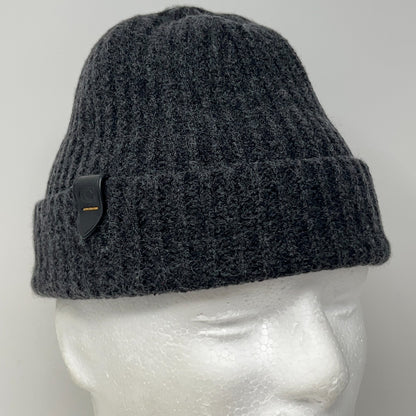 Black beanie featuring a ribbed texture and logo patch, shown from the front on a mannequin head