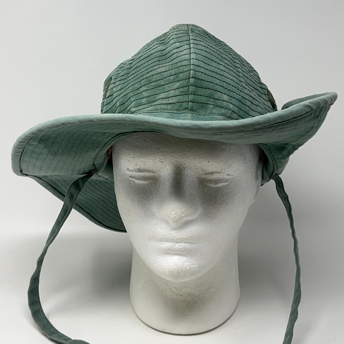 Unbranded green Bush Hat with wide brim and chin straps, showing front view and textured pattern