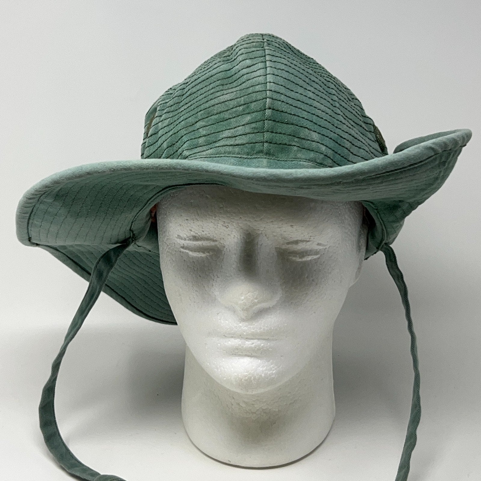 Unbranded green Bush Hat with wide brim and chin straps, showing front view and textured pattern