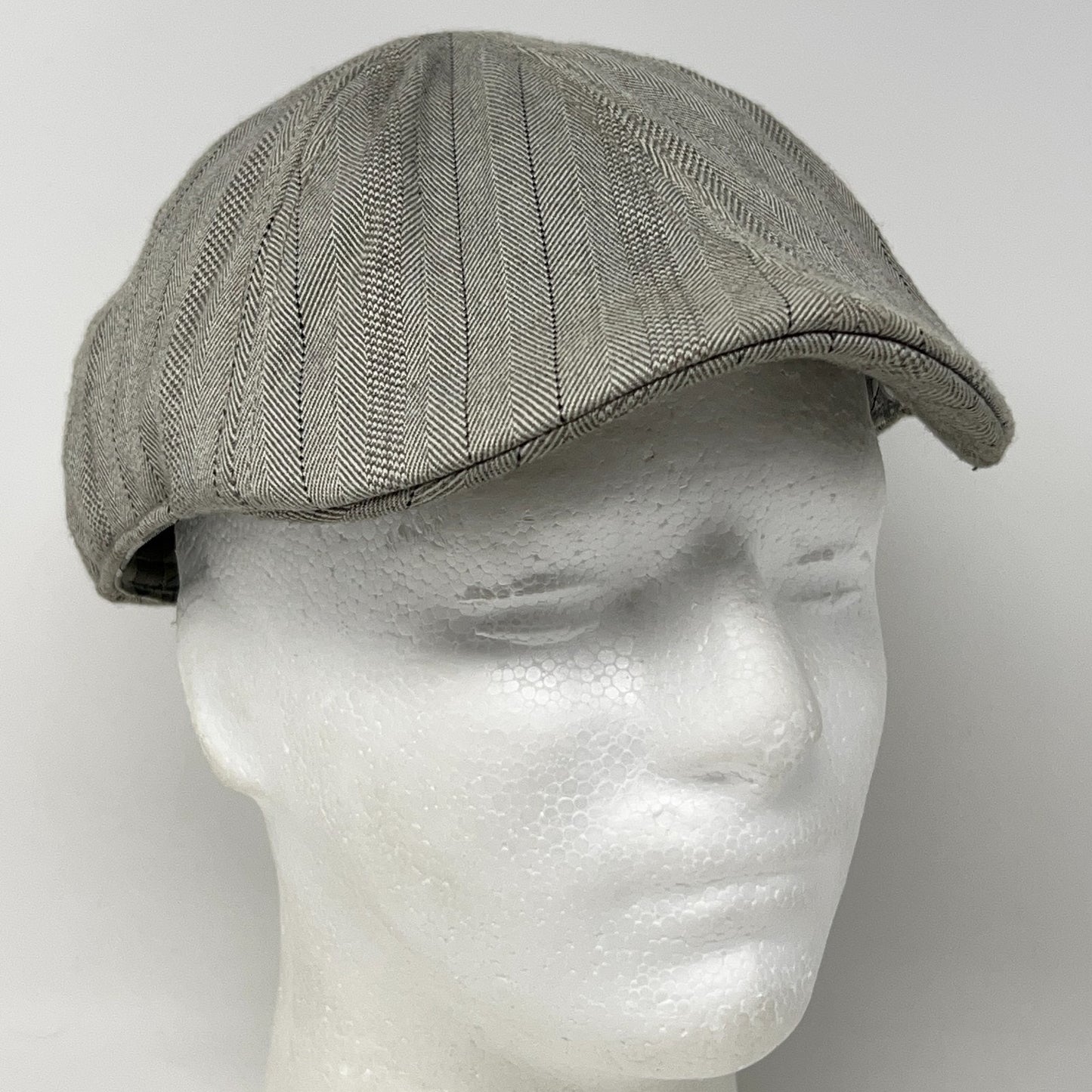 Vintage Stone Gray Flat Cap featuring herringbone pattern, viewed from the front on mannequin head