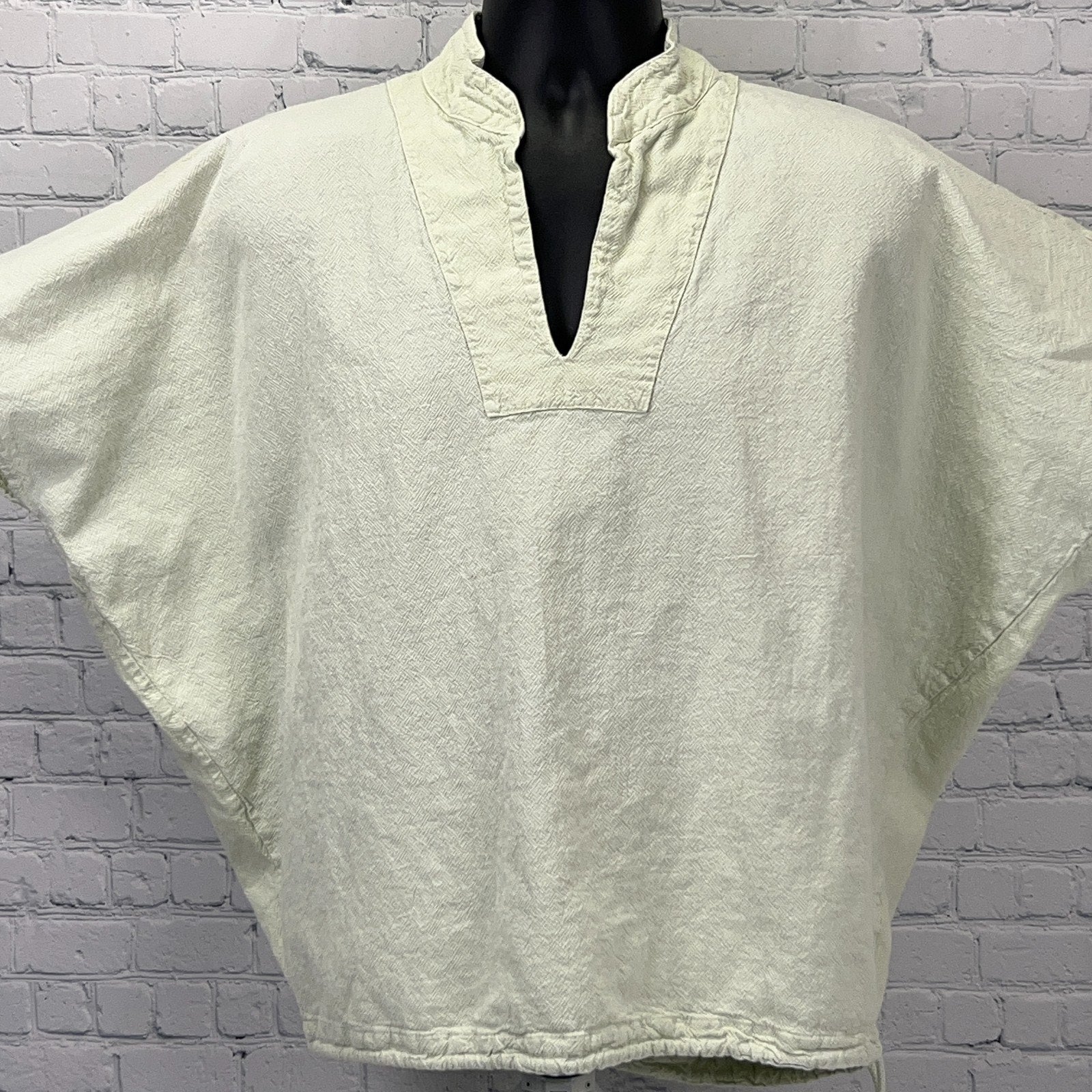 Light green oversized poncho with a V-neck design, perfect for casual wear
