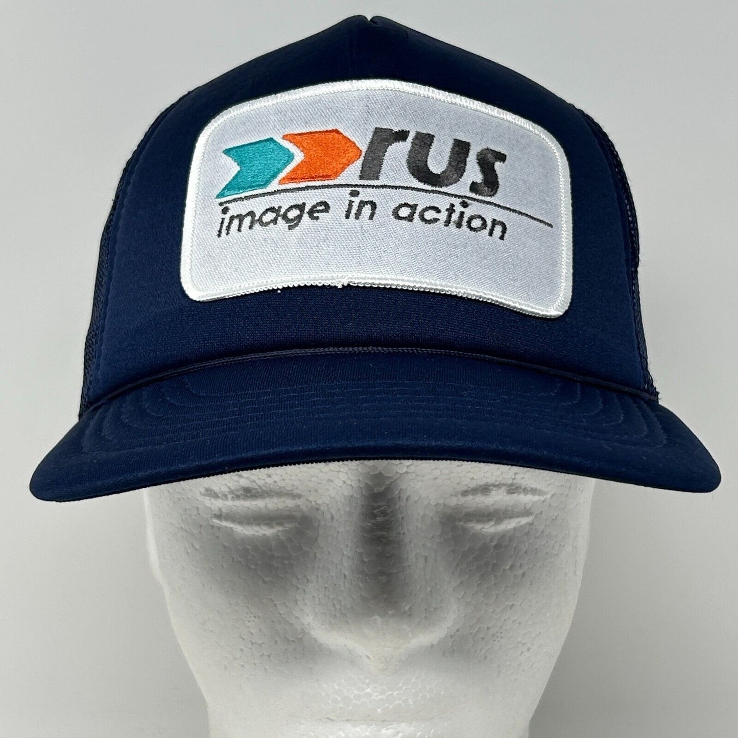 Vintage navy blue cap with 'rus' logo patch and adjustable snapback design