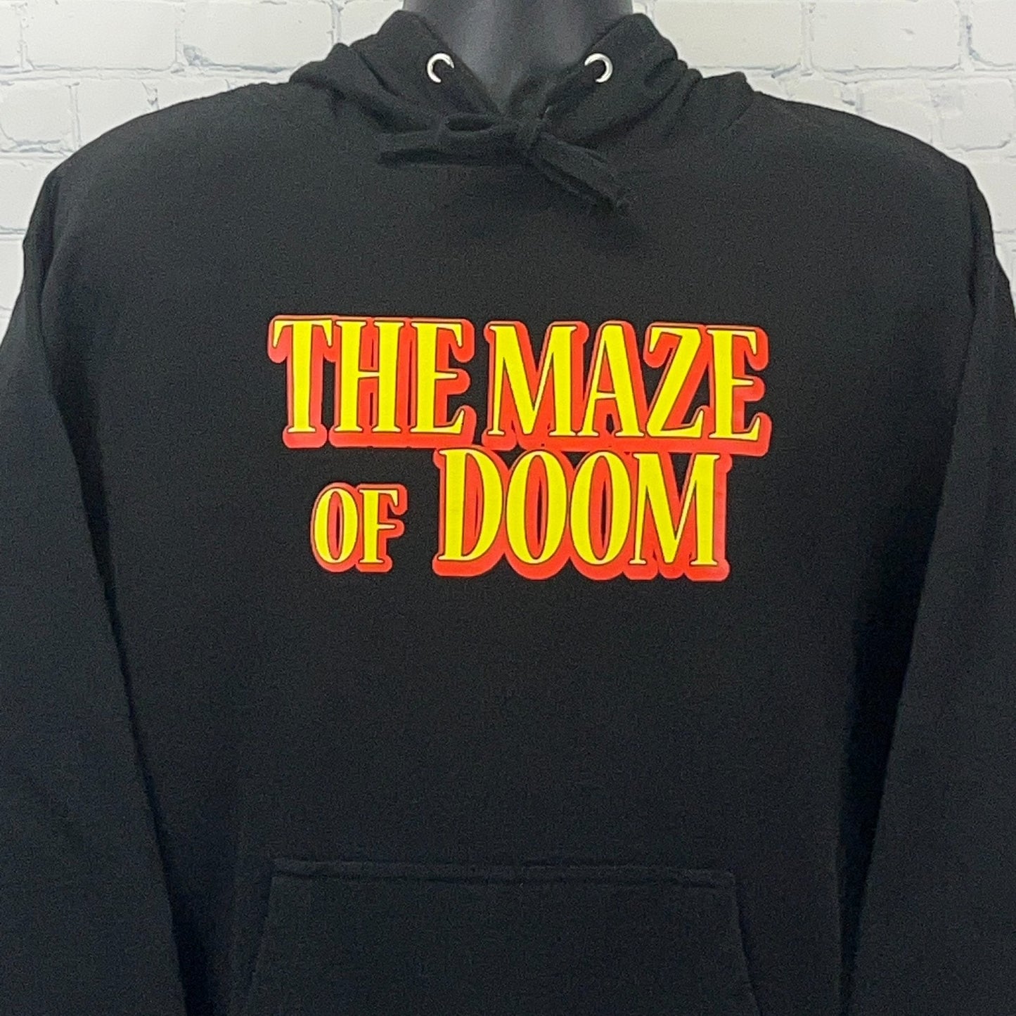 Black hoodie from Independent Trading Company featuring 'The Maze of Doom' bold graphic on the front