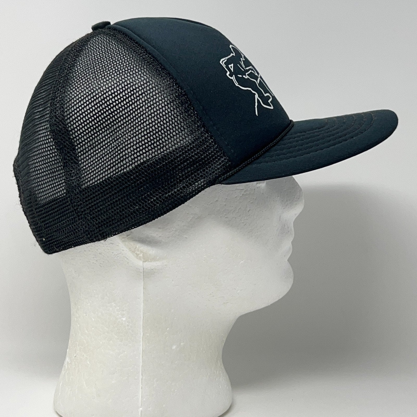 Vintage trucker cap in black, side view showcasing the mesh design